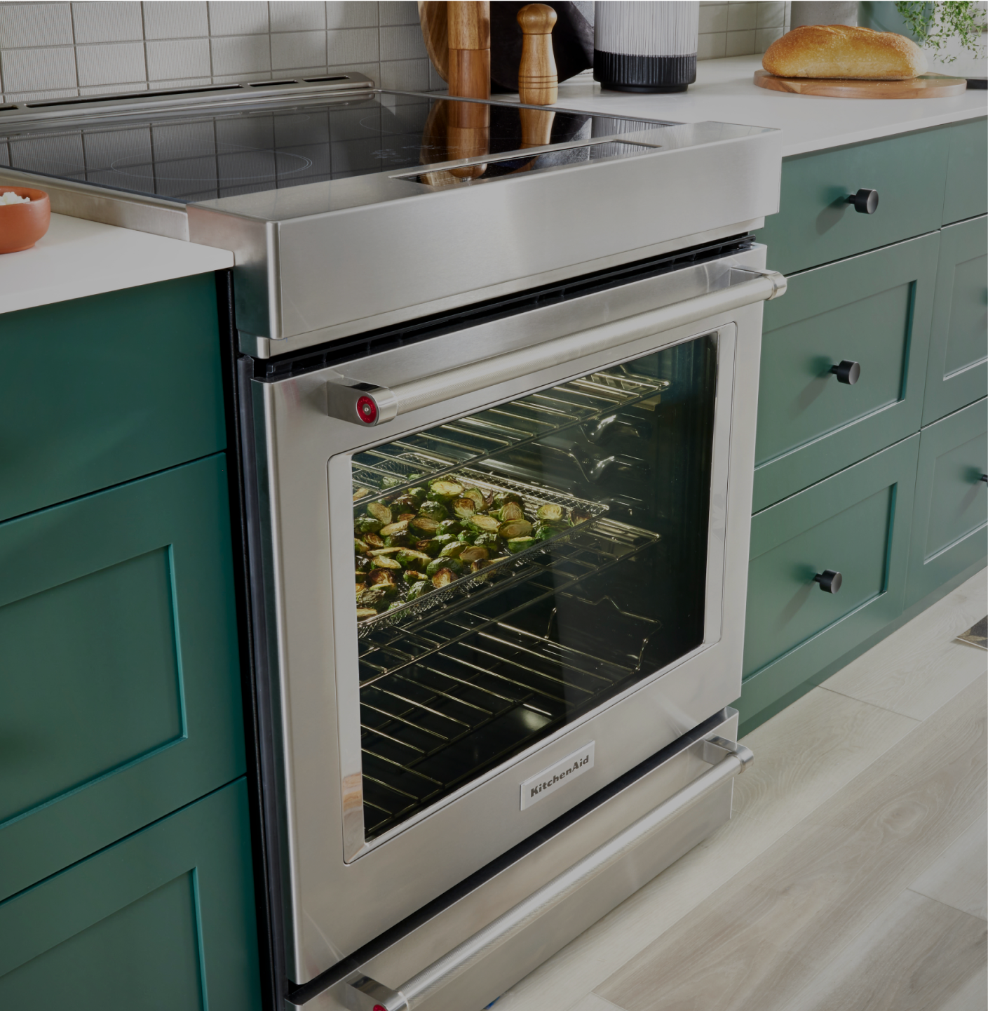 A KitchenAid® range with food cooking inside.